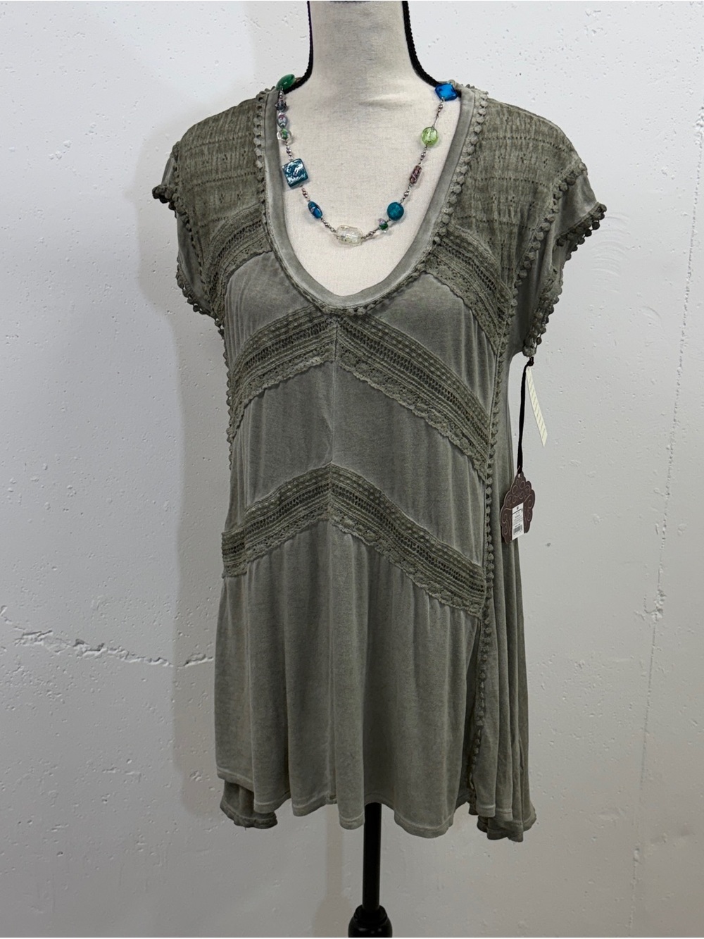 NWT Womens Olive Green Crochet-Trim V-Neck Tunic Fabric has a wash effect on it